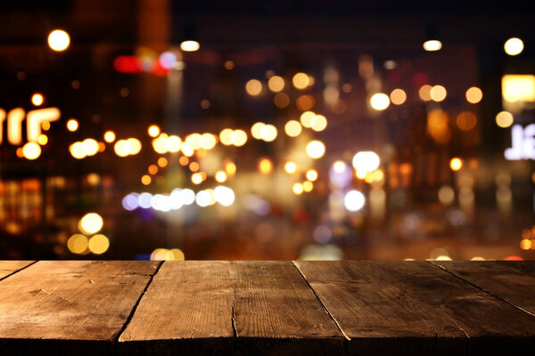 background Image of wooden table in front of street abstract blurred lights view