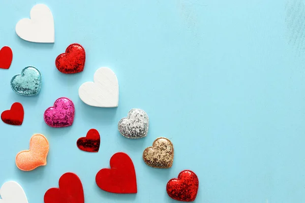 Concepto de San Valentín. muchos corazones sobre fondo azul madera. Composición laica plana — Foto de Stock