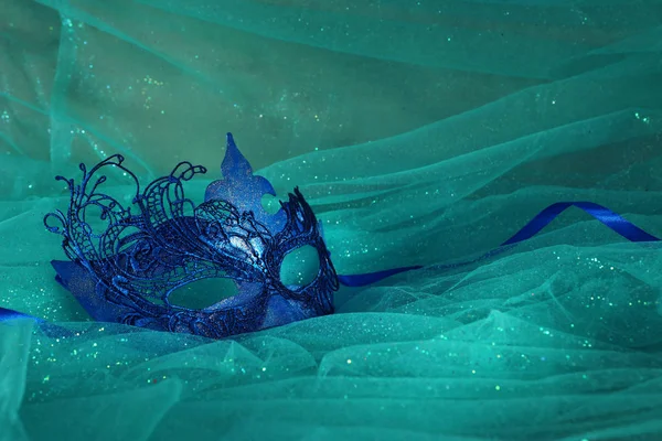 Photo of elegant and delicate blue Venetian mask over mint chiffon background — 스톡 사진