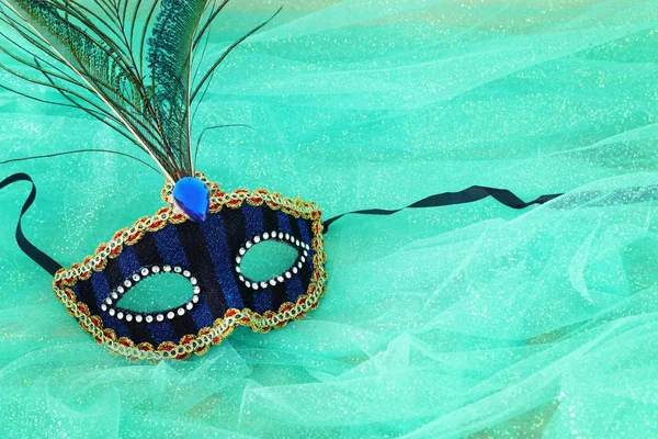 Foto van elegante en delicate blauwe Venetiaanse masker over mint chiffon achtergrond — Stockfoto