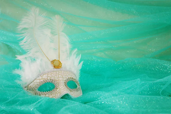 Photo of elegant and delicate white Venetian mask over mint chiffon background — 스톡 사진