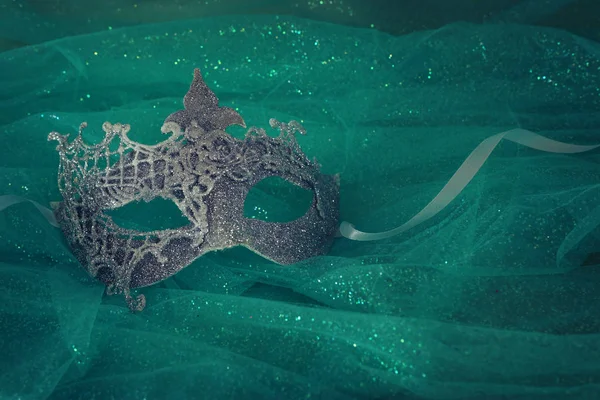 Photo of elegant and delicate white Venetian mask over mint chiffon background — Stock Photo, Image