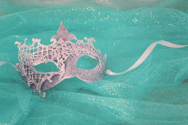 Photo of elegant and delicate white Venetian mask over mint chiffon background — 스톡 사진