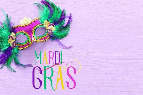 Holidays image of mardi gras masquarade venetian mask over purple background. view from above — Stock Photo, Image