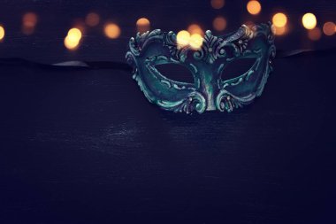 Zarif ve narin mavi Venedik maskesinin koyu ahşap arka planda fotoğrafı