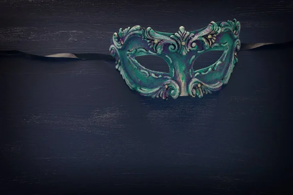 Photo of elegant and delicate blue Venetian mask over dark wooden background — 스톡 사진