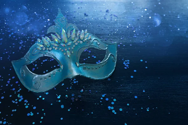 Photo of elegant and delicate blue Venetian mask over dark wooden background — 스톡 사진