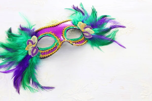 Photo of elegant and delicate Venetian mask over white wooden background — Stock Photo, Image