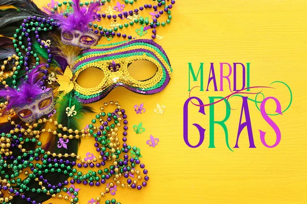 Holidays image of mardi gras masquarade venetian mask over yellow background. view from above — Stock Photo, Image