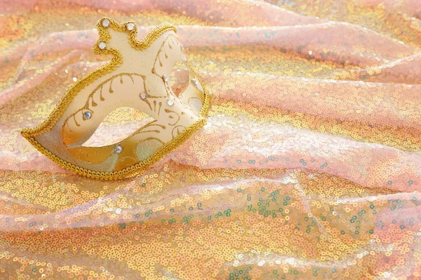 Foto van elegante en delicate Venetiaanse masker over mooie gouden en roze pailletten stof achtergrond — Stockfoto
