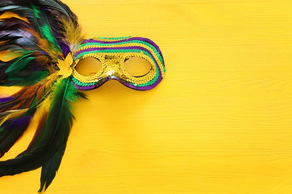 Sváteční obraz mardi gras maškarády benátské masky přes žluté pozadí. pohled shora — Stock fotografie