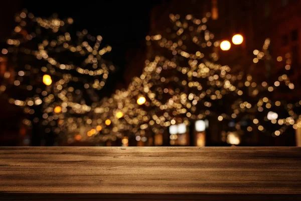 Background Image of wooden table in front of street abstract blurred lights view — 스톡 사진