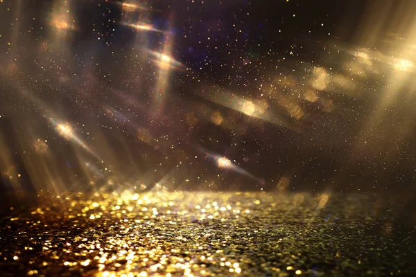 Hintergrund abstrakter Glitzerlichter. Gold und Schwarz. de fokussiert — Stockfoto