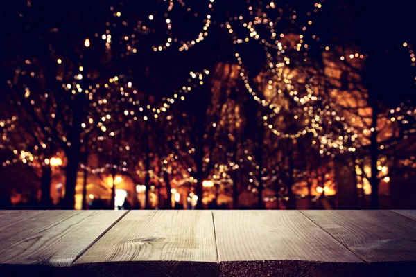 Background Image of wooden table in front of street abstract blurred lights view — 스톡 사진