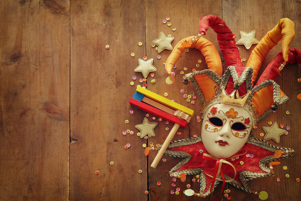 Purim celebration concept (jewish carnival holiday) over wooden background. Top view, flat lay