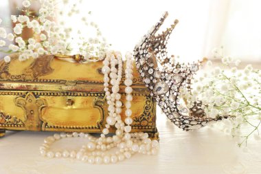 Vintage crown, antique jewellery box and pearls necklace. Wedding concept. Back light clipart