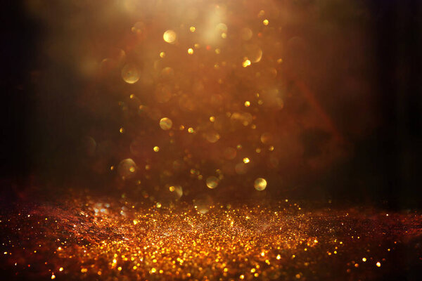 Background of abstract glitter lights. gold, blue and black. de focused