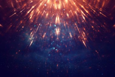 Soyut parıltılı ışıkların arkaplanı. Altın, mavi ve siyah. & Odaklan