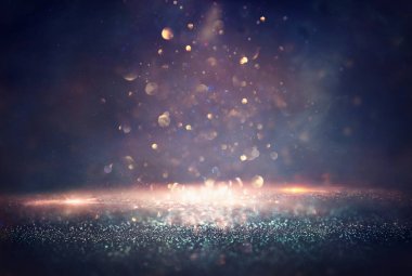 Soyut parıltılı ışıkların arkaplanı. Altın, mavi ve siyah. & Odaklan