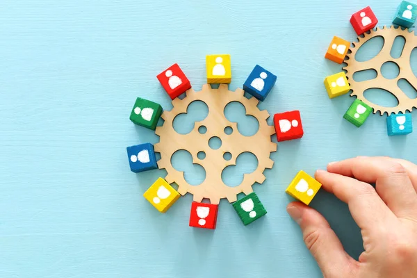 image of colorful blocks with people icons over wooden table ,human resources and management concept