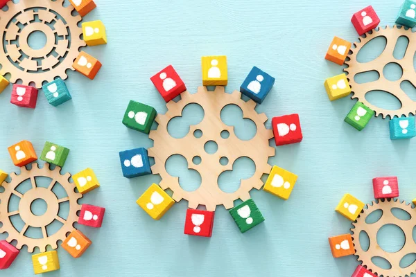 image of colorful blocks with people icons over wooden table ,human resources and management concept