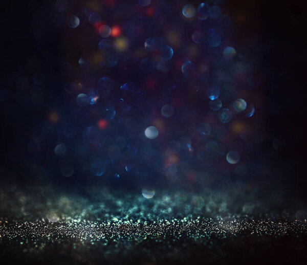 background of abstract glitter lights. blue and black. de focused