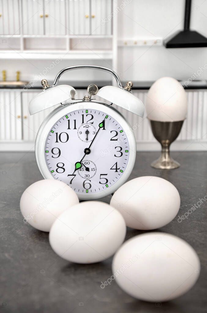 white clock and alarm clocks, on a light background.