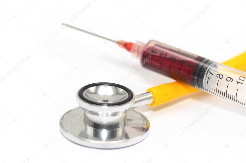syringe with a needle and a stethoscope on a white background.