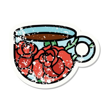 Geleneksel bir fincan ve çiçek stili dövmesi var.