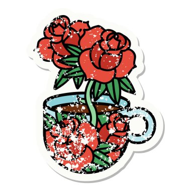 Geleneksel bir fincan ve çiçek stili dövmesi var.