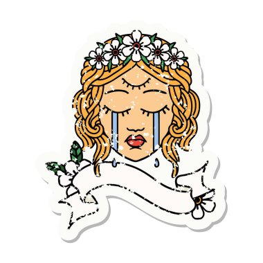 Üzerinde kadın yüzü bayrağı olan eski bir etiket üçüncü gözü ve çiçek tacıyla halka şeklinde.