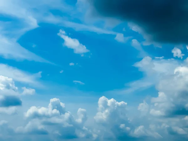 Blue sky with tiny floating clouds closeup. The moody Blues natural sky composition. Beauty in nature. Travel tourism and environment background design Element. Copy space room for text in top middle. — 스톡 사진