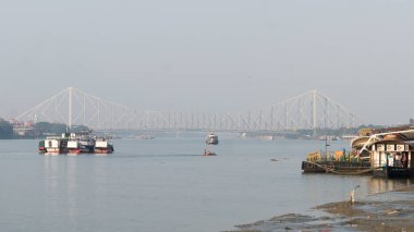 Panoramic Scenics Howrah bridge over Hooghly river. Photography in winter sunset from Babu Ghat Calcutta Riverside Area Kolkata, West Bengal, India, South Asia Pac January 2020