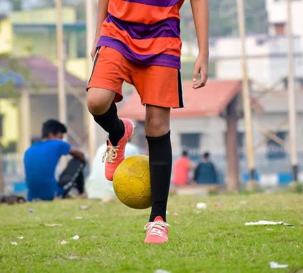 Soccer player in sports uniform juggling a football in sports field. Summer winter Olympics games Sports activities background Photography.
