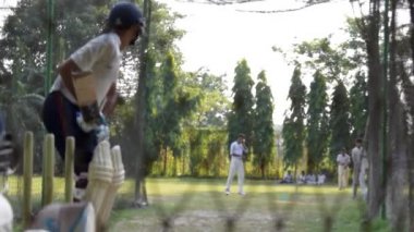 Spor formalı kriket oyuncusu, spor kulübü akademisinin kriket sahası stadyumunda hem sporcu hem de bovling antrenmanı için Nets Sessions 'da vuruş yapıyor. Kolkata Hindistan Mart 2020