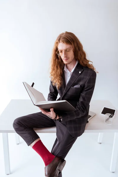 Stylish Tattooed Businessman Curly Hair Sitting Table Reading Documents — Free Stock Photo