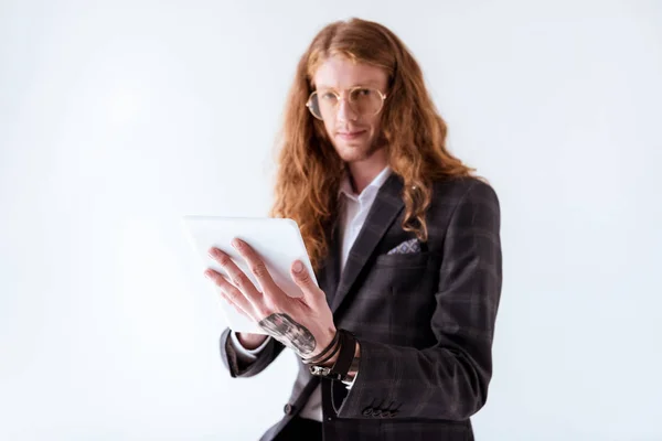 Elegante uomo d'affari tatuato con capelli ricci tablet tenuta isolata su bianco — Foto stock