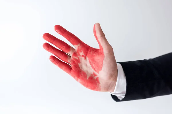 Cropped image of businessman showing hand in red paint isolated on white — Stock Photo