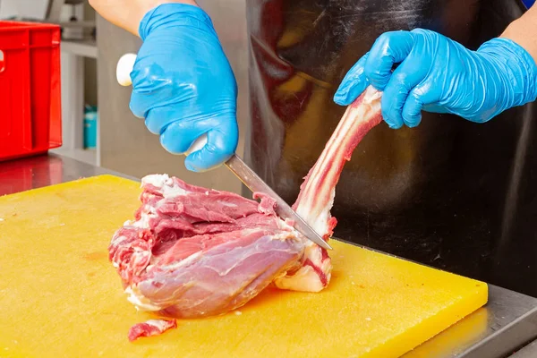 meat production workshop, butcher\'s hands in work