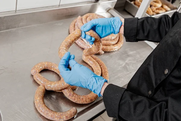 Meat processing plant, sausage production, hands in work