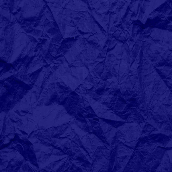 Blue wrinkled paper. Texture of craft paper phantom blue colors. Recycled paper background.