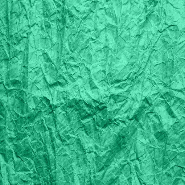 Mint color crumpled wrapping paper. Texture of old ragged craft paper aqua menthe color. Recycled paper background.