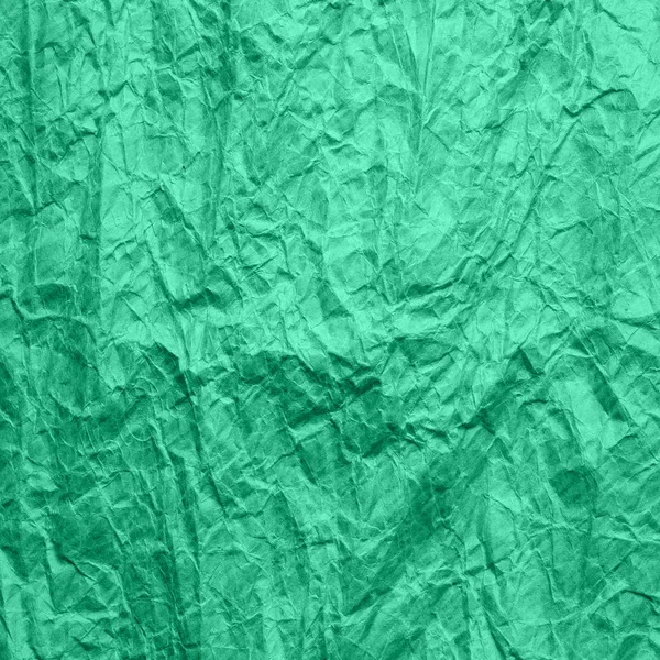 Mint color crumpled wrapping paper. Texture of old ragged craft paper