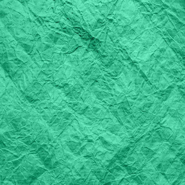 Mint color crumpled wrapping paper. Texture of crumpled kraft paper of aqua menthe color. Recycled paper background.