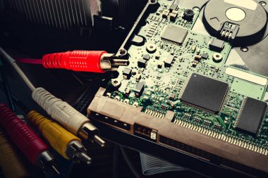 Hard drive and cables. Old computer hard drive. Microchips and PC components, storage data and information recovery.