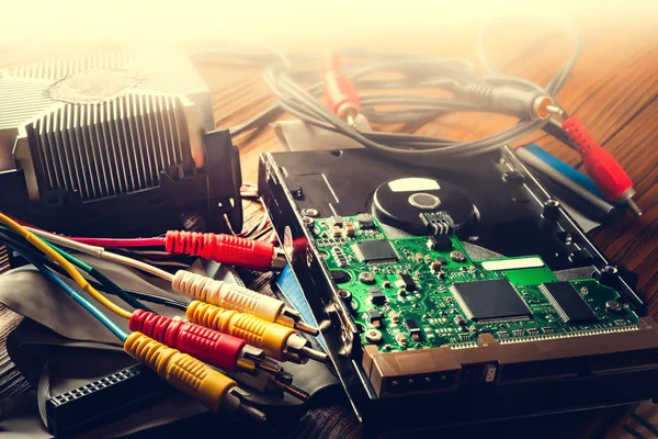 Close-up of computer parts and wires. Old computer hard drive and cables. Chip and PC components, data storage and recovery of information.