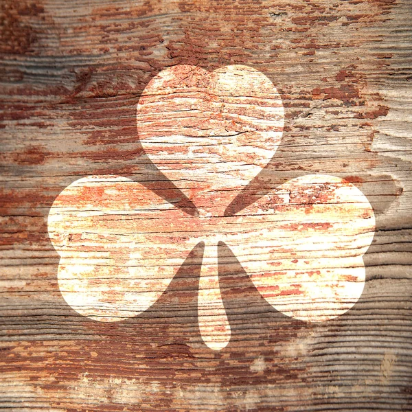 St. Patrick's Day. Bright trace three-sheeted clover on a wooden surface. — Stock fotografie