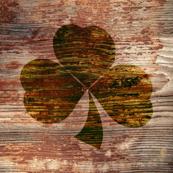 St. Patrick's Day. Dark trail of three leaf clover on a wooden surface. — Zdjęcie stockowe