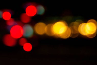 Bokeh araba farları. Şehirdeki sokak lambalarının ve arabaların farlarının bulanık görüntüsü. Bokeh elementleri. Montaj ve tasarım için yaratıcı arkaplan.