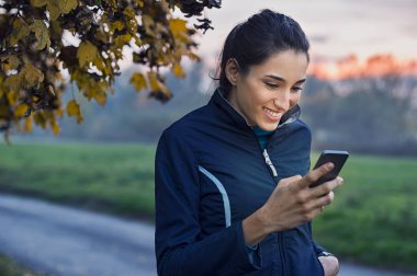 Telefon kullanan sportif kadın